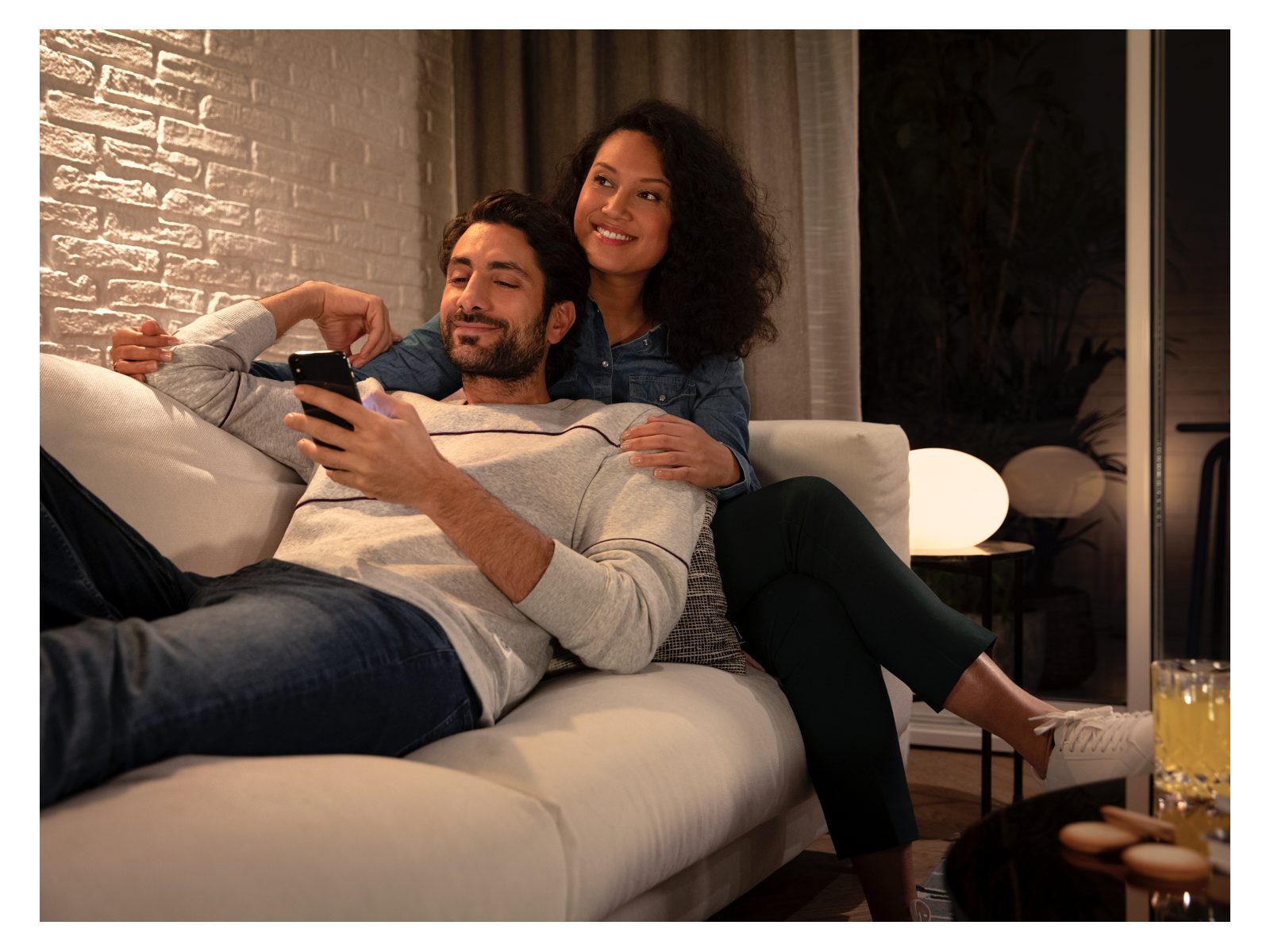 2 people on a sofa with soft mood lighting