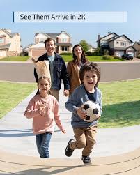 2 adults and 2 children walking up to a front door from the view of the video doorbell