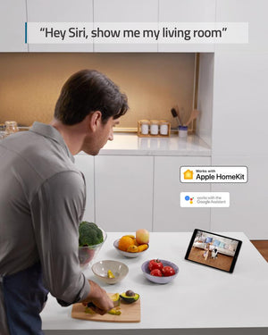 a man in the kitchen watching a tablet device. the caption reads, hey siri, show me my living room.  the image has the apple homekit and google assistant logos embedded