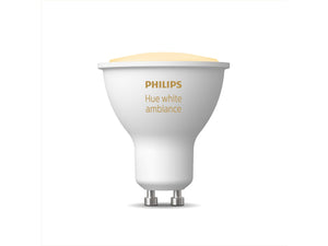 A Philips hue GU10 smart white ambient light bulb shown with light on