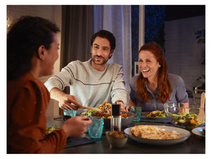 3 people at a dining table smiling