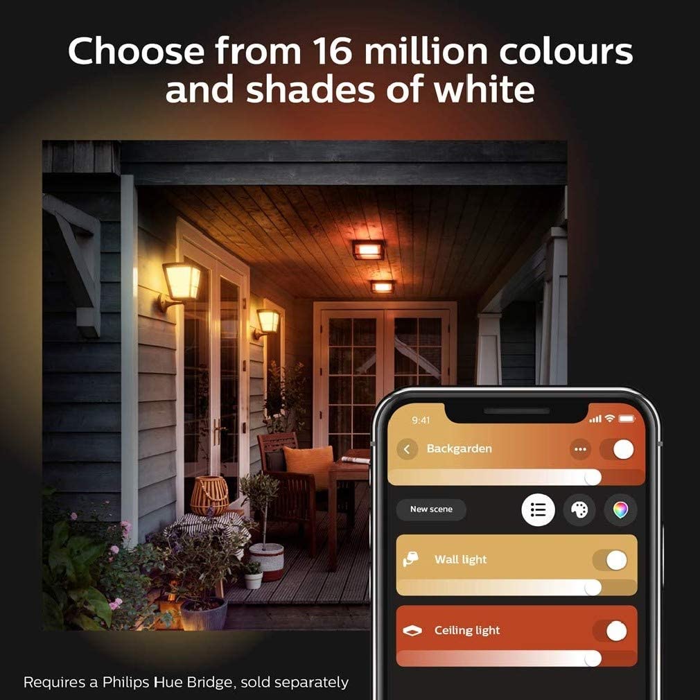 A porch with several philips hue econic wall lanterns shining a warm light.  A mobile phone showing the philips hue app being used